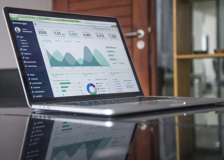 Google Ads vs Meta Ads performance analytics on a laptop