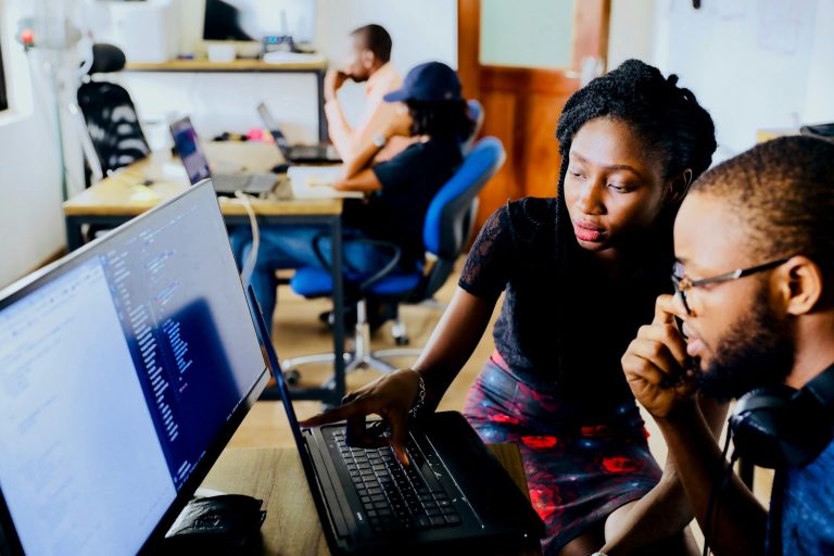 Web developers reviewing code together - how to choose a web development company
