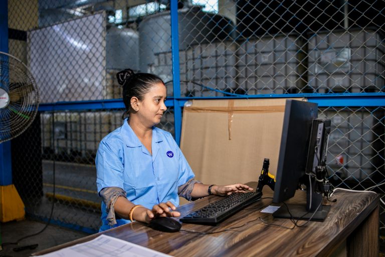 Warehouse manager checking stock on a computer, one of the signs your business needs an ERP system